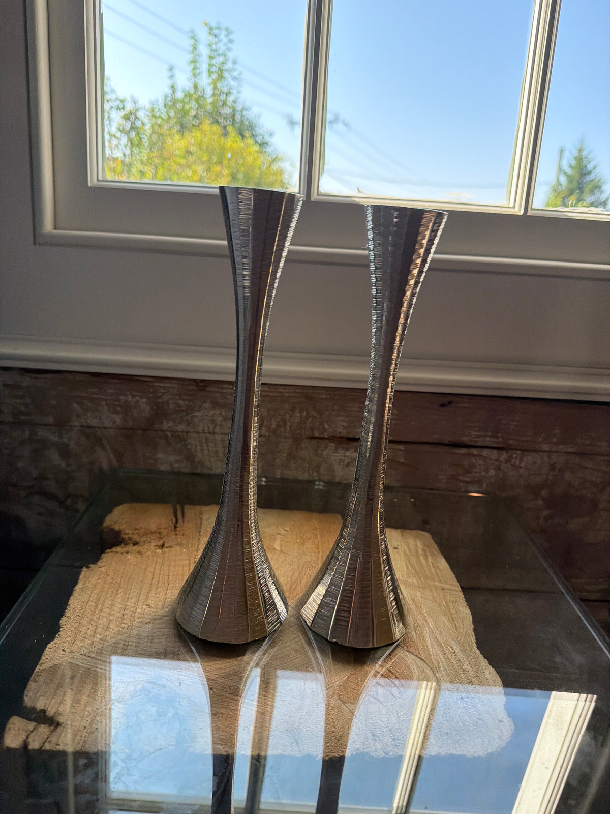 Pair of silver colored candlesticks