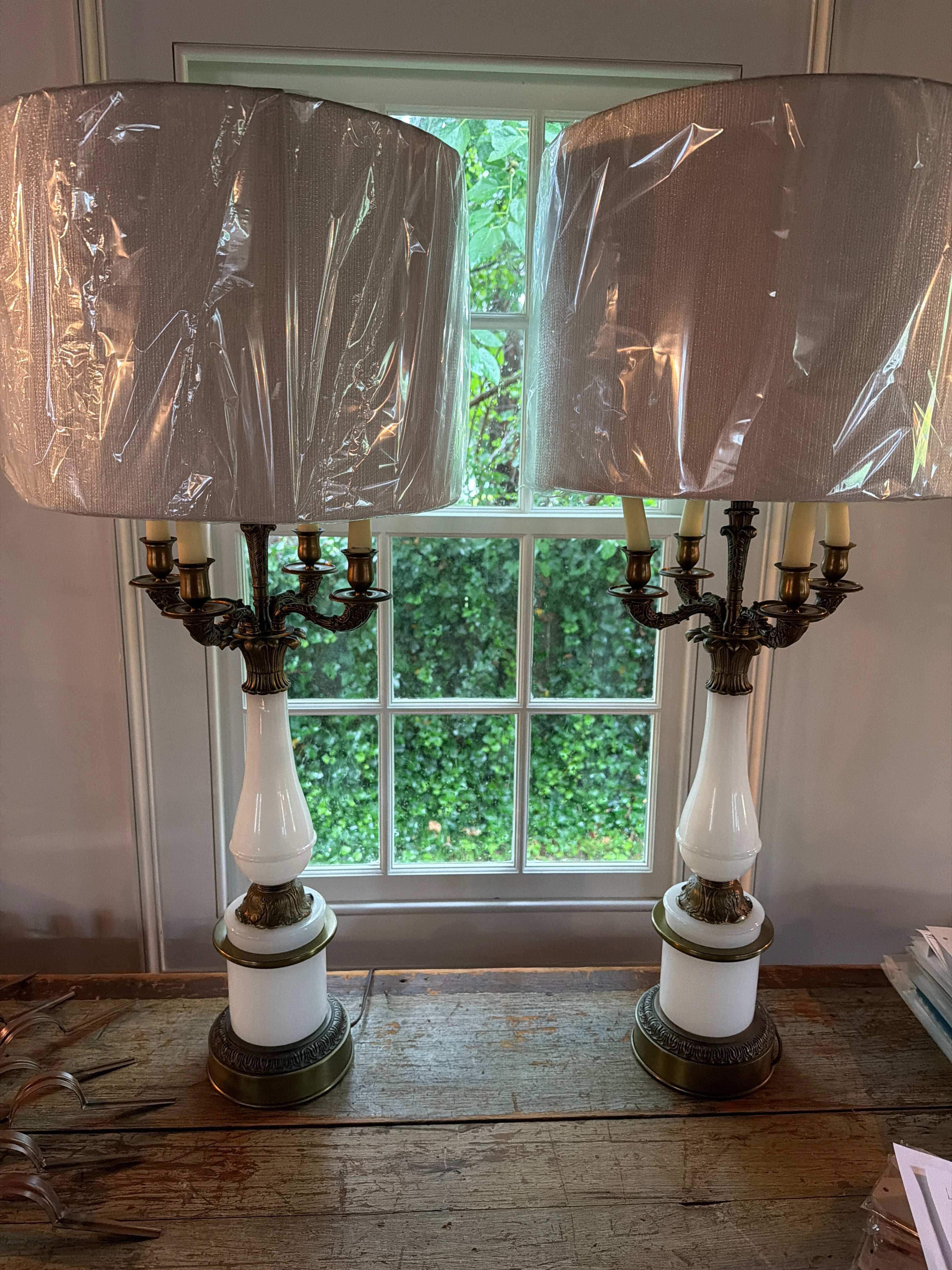 Pair of Hollywood regency style opaque white glass and guilt bouillotte table lamps.