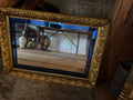 Large vintage gold gilt mirror with blue stained glass insert.