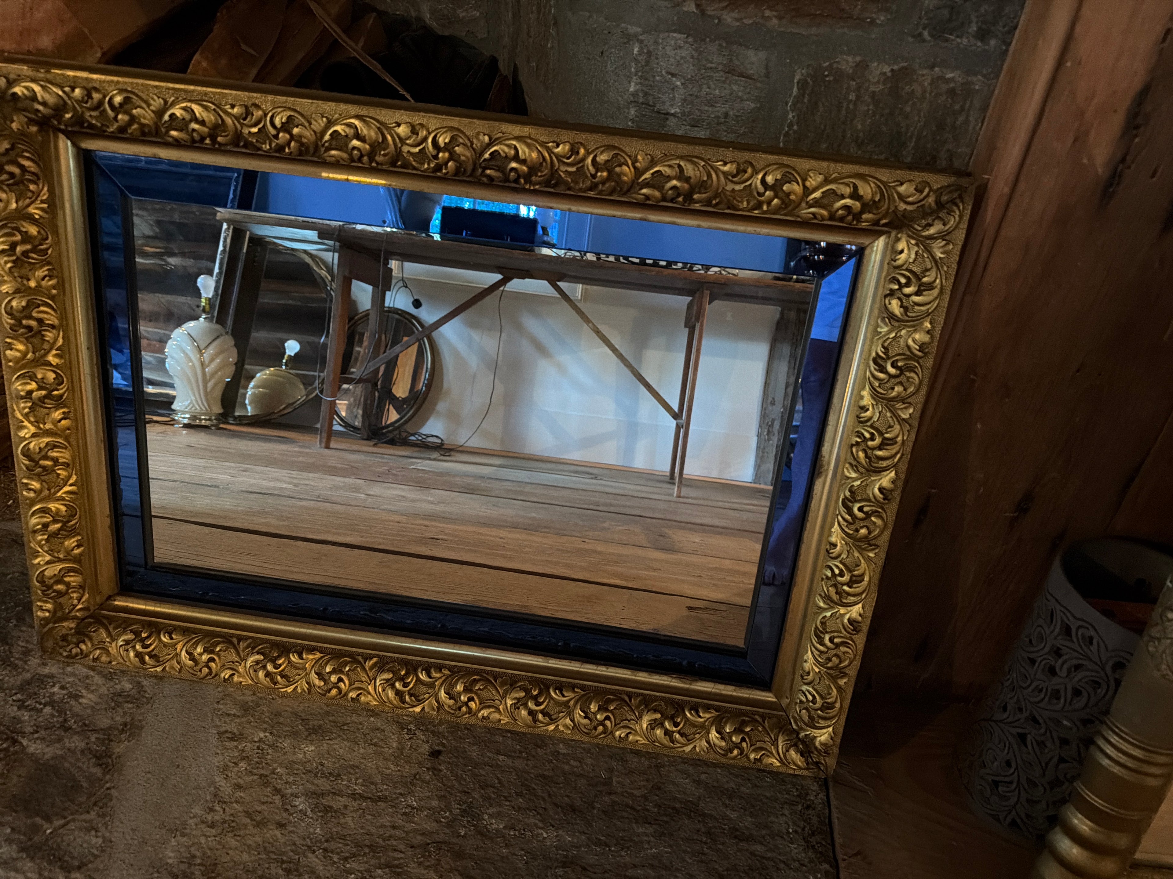Large vintage gold gilt mirror with blue stained glass insert.